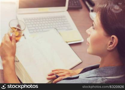 Beautiful brunette smart female at work, rear view of a woman reading something important, casual day of a people in the office