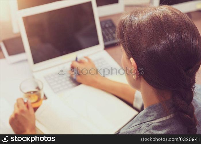 Beautiful brunette smart female at work, rear view of a woman reading something important, casual day of a people in the office