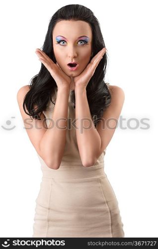beautiful brunette with short elegant dress and colored makeup, she looks in to the lens with expression of surpraise, her hands are both near the face