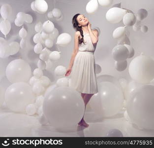 Beautiful brunette wman on balloon background
