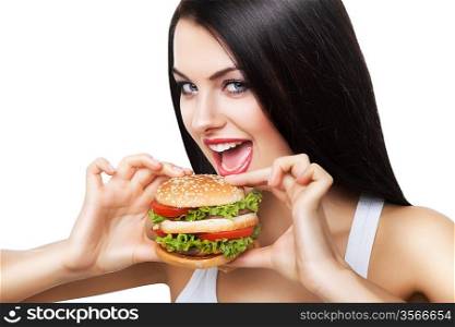 beautiful brunette woman biting hamburger on white background