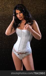 Beautiful brunette woman in a white corset