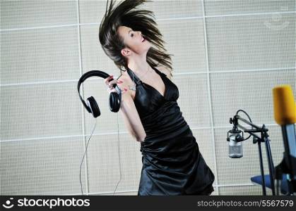 beautiful brunette woman playing and dancing with music headset