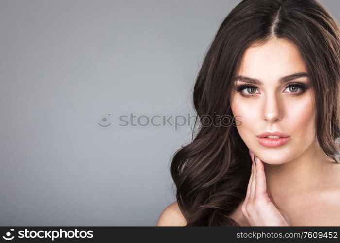 Beautiful brunette woman portrait, healthy hair, clear fresh skin, girl on gray background with copy space for text, skincare., spa, beauty model. Beautiful brunette woman portrait