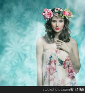 beautiful brunette woman posing in spring shoot with some flowers on the head and floral dress, natural make-up and hair-style. looking in camera with sensual expression