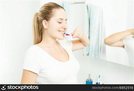 Beautiful brunette woman posing with tooth brush at bathroom