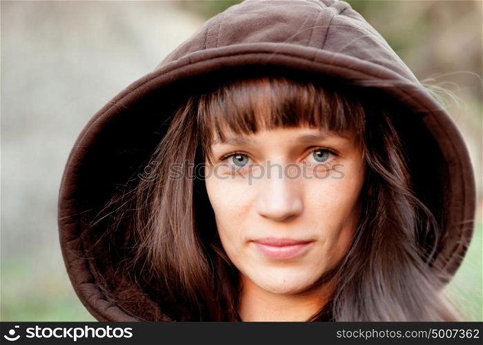 Beautiful brunette woman with brown wood in the park