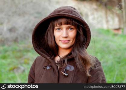 Beautiful brunette woman with brown wood in the park