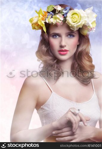 Beautiful, brunette woman with colorful makeup, wreath of flowers on head, little bird on her finger.