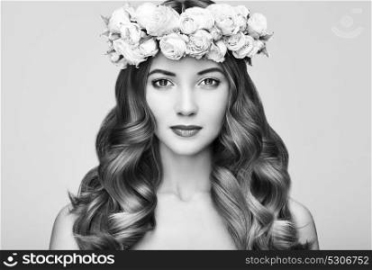 Beautiful Brunette Woman with Flower Wreath on her head. Beauty girl with Flowers Hairstyle. Perfect Makeup. Beauty Fashion. Spring Woman