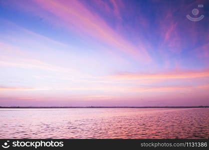 Beautiful burning dramatic sunrise or sunset sky over wide peaceful Nong Harn lake, Udonthani - Thailand.