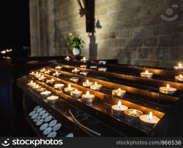 Beautiful, burning, festive candles in the darkness of the old Church. Beautiful, festive candles in the darkness of the old Church
