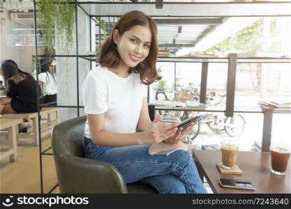 Beautiful business girl working with tablet , smartphone and drinking coffee in coffee shop