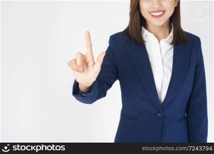 Beautiful Business Woman in blue suit is touching virtual screen on white background