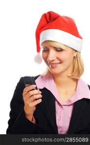 Beautiful business woman in Christmas hat typing message on her mobile phone
