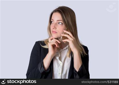 Beautiful business woman in suit, talking on the mobile phone on studio.