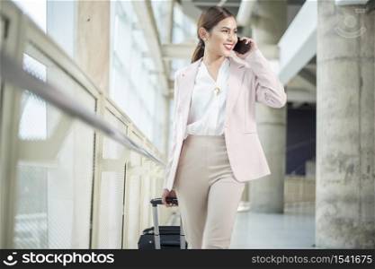 Beautiful business woman is walking in Airport , Business travel concept