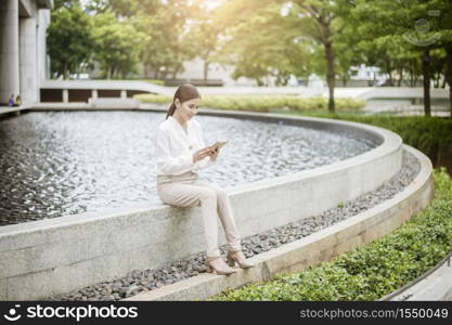 Beautiful business woman is working outside office