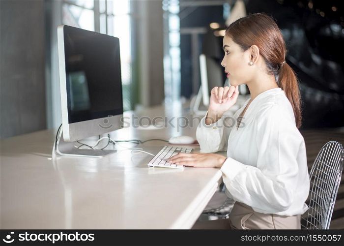 Beautiful business woman is working with her computer