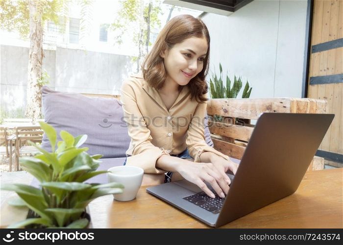 Beautiful business woman is working with her laptop in coffee shop