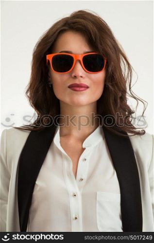 Beautiful business woman wearing sunglasses over a white background