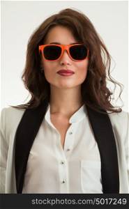 Beautiful business woman wearing sunglasses over a white background