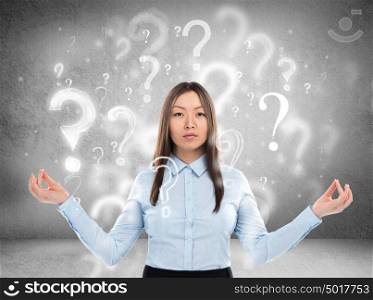 Beautiful business woman with question marks above her head