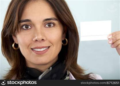 beautiful businesswoman displaying her business card smiling