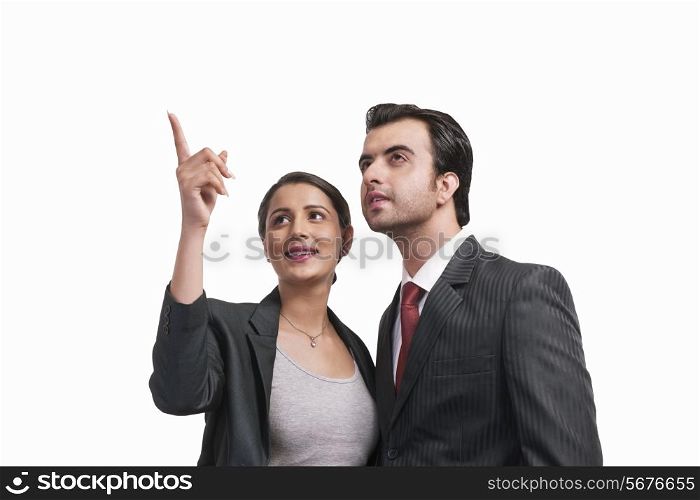 Beautiful businesswoman showing something to colleague over white background