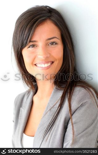 Beautiful businesswoman standing on grey background