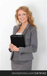 Beautiful businesswoman standing on white background with agenda