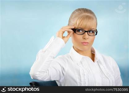 Beautiful businesswoman touches the glasses at office