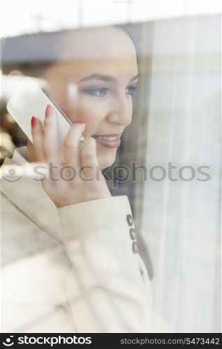 Beautiful businesswoman using cell phone in office