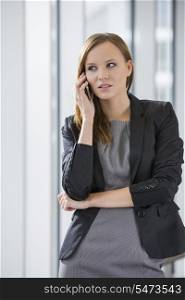 Beautiful businesswoman using cell phone in office