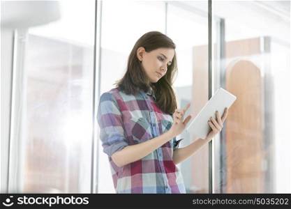 Beautiful businesswoman using digital tablet in office