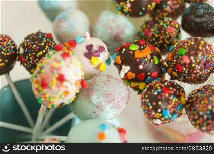 Beautiful cake pops and candies decorated with sprinkles