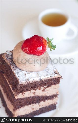 beautiful cake with strawberry and tea on a white background