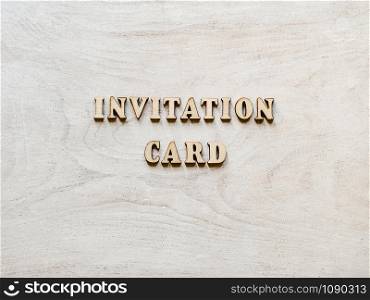 Beautiful card with unpainted wooden letters lying on a white board. Top view, close-up. Isolated background. Congratulations to loved ones, relatives, friends, colleagues. Beautiful card with unpainted wooden. Top view
