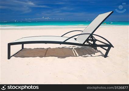 Beautiful caribbean beach with chaise lounge in Dominican Republic