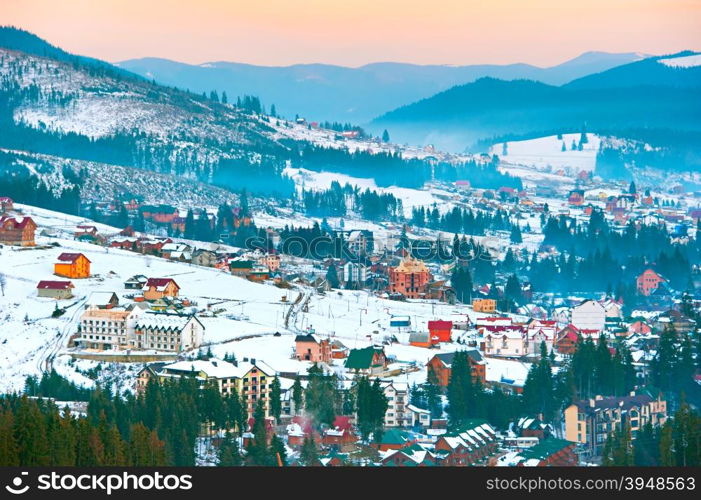 Beautiful Carpathians mountain village in the winter at sunset. Ukraine