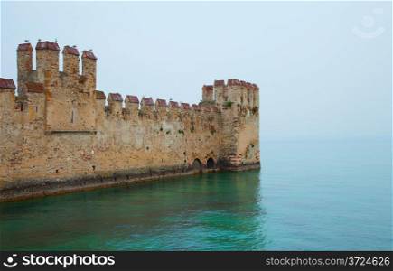 Beautiful castle of Sirmione, Italy, extending over the lake