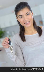 beautiful caucasian woman holds keys