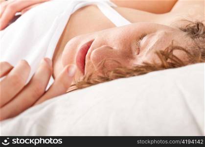 beautiful caucasian woman is sleeping in bed at morning