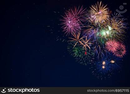 Beautiful celebration golden, red, purple, green sparkling fireworks. New Year beautiful fireworks. Holidays symbol background. Independence Day, 4th of July holidays salute.. Beautiful celebration sparkling fireworks over starry sky, copy