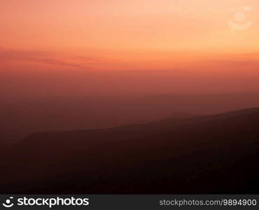 Beautiful charming dramatic sunset gradient shade mountain landscape of Phu Kradueng National park. Loei, Thailand. Warm tone image