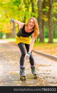 beautiful cheerful girl roller skate active in the autumn park