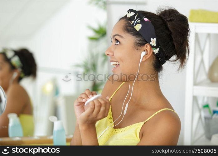 beautiful cheerful young woman listening to the music