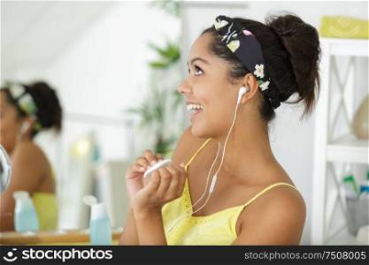beautiful cheerful young woman listening to the music