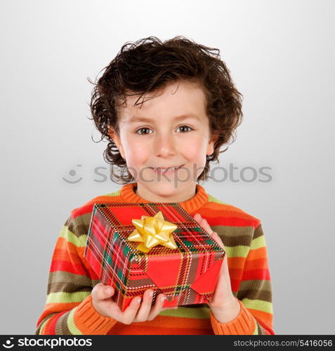 Beautiful child giving a present isolated on grey background
