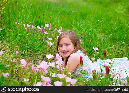 beautiful children girl on spring meadow with poppy flowers